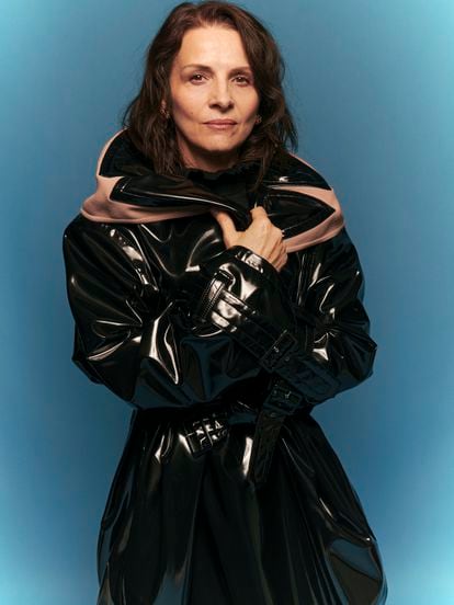 “You don't have to aspire to perfect love, because we aren't perfect either,” says Juliette Binoche, wearing a leather trench coat by Alaïa and earrings from Grassy.