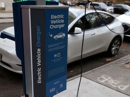 A electric vehicle charger is seen as a vehicle charges in Manhattan, New York, U.S., December 7, 2021.