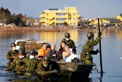 Soldiers assist with the evacuation of Minami Sanriku, in Miyagi.