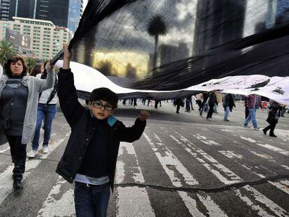 A child marches in a protest held to remember the 43 murdered students in Iguala.