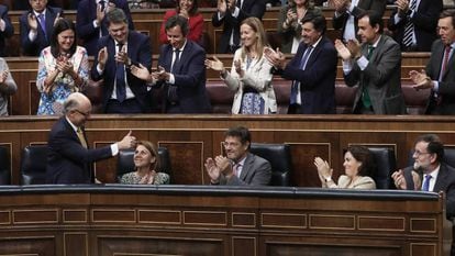 Deputies with Spain's ruling Popular Party applaud following the budget vote.