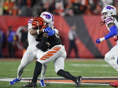 The moment of impact between Bills safety Damar Hamlin (left) and Tee Higgins of the Bengals.