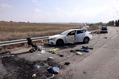 Personal belongings including a child's pram are seen on the road next to a car days after a mass infiltration by Hamas gunmen from the Gaza Strip, near Kibbutz Kfar Aza, in southern Israel, October 10, 2023. 
