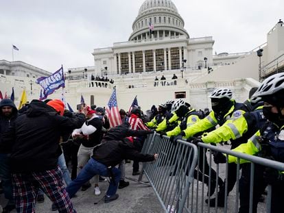 Violent insurrections loyal to President Donald Trump try to break through a police barrier at the Capitol in Washington on Jan. 6, 2021.
