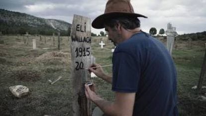 Association founder Sergio García paints the fictitious grave marker for Eli Wallach.