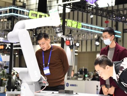 Visitors tour the industrial robot exhibition area at the 2023 World Intelligent Manufacturing Conference in Nanjing, China, on December 6, 2023.