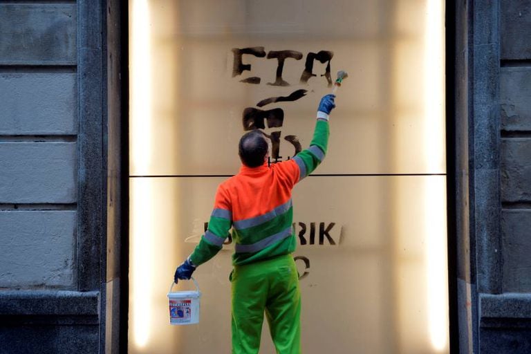 A worker cleans graffiti in support of Basque terror group ETA.