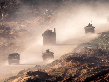 Israeli army Humvees and vehicles move along a dirt road in the Gaza Strip near a position along the border with southern Israel on January 4, 2024.