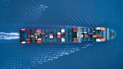 A large container ship loaded with cargo approaches the port in Shanghai, China.
