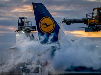 A Lufthansa aircraft is de-iced at the airport in Frankfurt, Germany, Sunday, Feb. 26, 2023.
