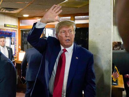 Former President Donald Trump waves as he departs after a visit with campaign volunteers at the Elks Lodge, Tuesday, July 18, 2023, in Cedar Rapids, Iowa.