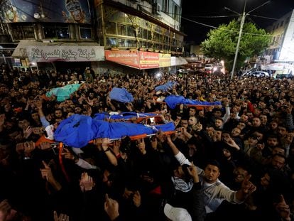 Mourners carry the bodies of Palestinians who were killed by Israeli troops during a raid in Jenin in the Israeli-occupied West Bank on March 7, 2023.