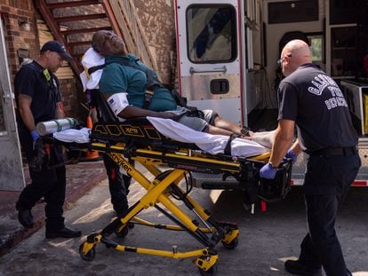Paramedics with the Galveston County Health District transport a resident to hospital after they said he overheated and fell in his kitchen during a heat wave in Galveston, Texas, on August 27, 2023.
