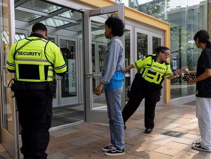 Security guards check identification for proof of age outside the Mall in Columbia, on May 12, 2023, in Columbia, Maryland.