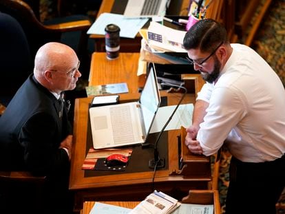 Iowa state Rep. Steven Holt, R-Denison, talks with House Majority Leader Matt Windschitl, right, in the Iowa House Chambers, May 23, 2022, at the Statehouse in Des Moines, Iowa.