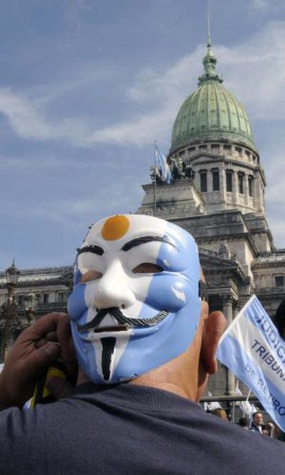 A protestor wears a Guy Fawkes mask during a protest in front of Congress at the time that the Chamber of Deputies was voting on two of six controversial judicial reforms.