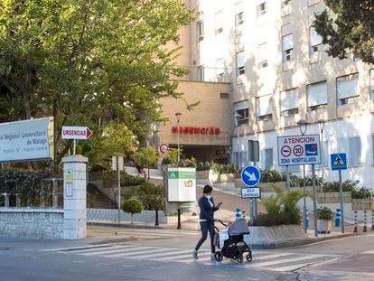 A woman walks past the entrance to the Málaga Regional University Hospital, formerly known as Carlos Haya Hospital.