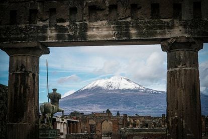 View of the snow-capped Mount Vesuvius, in an image taken from the ancient archaeological ruins of Pompeii, near Naples (Italy).