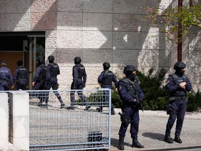 Police officers stand at the main entrance of an Ismaili Muslim center in Lisbon, Portugal, on March 28, 2023.