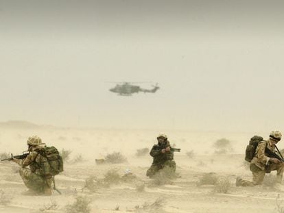 Soldiers attached to Britain's 3 Army Air Corps patrol the desert around the oil fields of north Ramaila in Iraq, during a sandstorm, March 25, 2003.