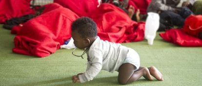 A baby crawls on the floor of a former sports center turned into an immigrant shelter in Tarifa last August.