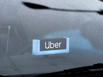 An Uber sign is displayed inside a car, May 15, 2020, in Chicago.