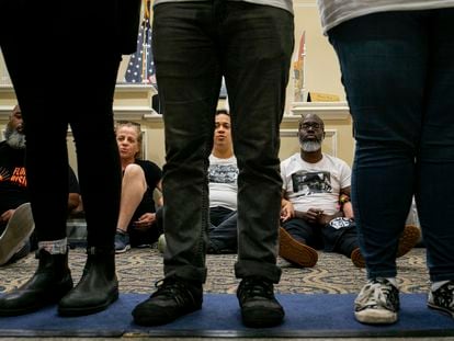 Dozens of activists stage a sit-in outside Florida Gov. Ron DeSantis' office and force people to step over them to reach DeSantis' office as they speak out against the governor and his policies, Wednesday, May 3, 2023, in Tallahassee, Florida