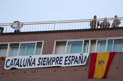 A banner with the phrase "Catalonia always Spain" hangs on a building on along the parade route.