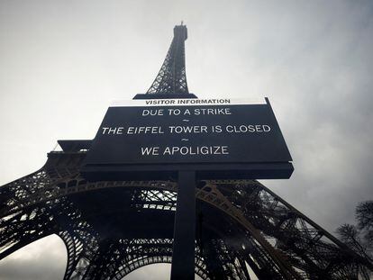 A sign reading 'Due to a strike, the Eiffel Tower is closed. We apoligize' hangs in front of the Eiffel Tower in Paris, France, February 19, 2024.
