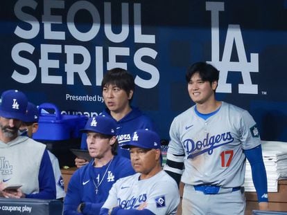 Los Angeles Dodgers star player Shohei Ohtani (R) and his interpreter Ippei Mizuhara (C) look at the Dodgers' MLB season-opening game against the San Diego Padres in Seoul, South Korea, 20 March 2024.