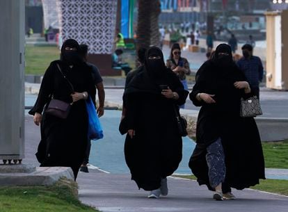 Three women strolling along Doha Bay, shortly before the start of the World Cup.