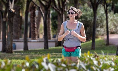 A woman running in a park in Valencia, Spain.