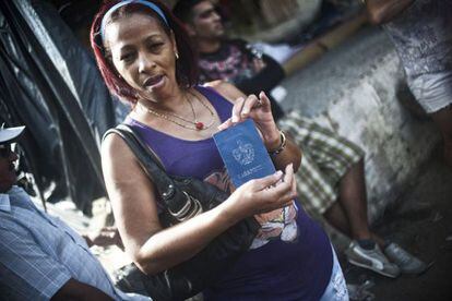 A Cuban migrant shows her passport at a shelter in La Cruz, Costa Rica.