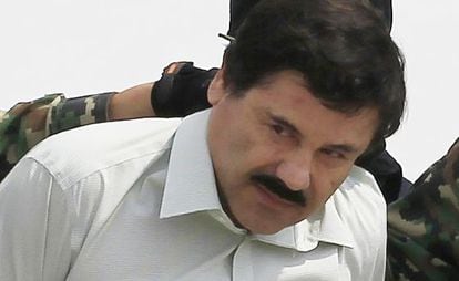 Joaquin 'El Chapo' Guzman is escorted by soldiers during a presentation at the navy's airstrip in Mexico City in 2011.