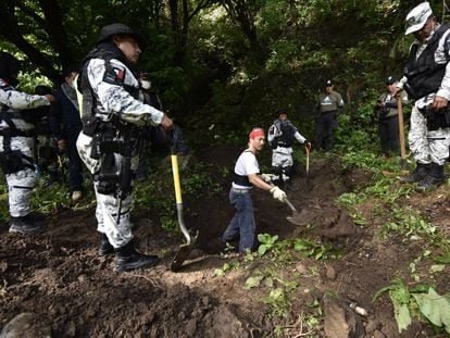 Members of Mexico's National Guard search for human remains in a grave in the state of Guerrero, in a file image.