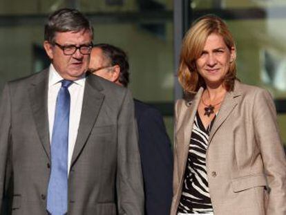 Princess Cristina and her secretary, Carlos García Revenga, after visiting the king in hospital following his recent operation.