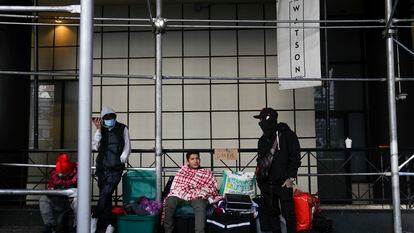 Migrants camp with their belongings on the sidewalk in front of the Watson Hotel in New York, on Jan. 30, 2023.