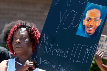 Lynnette Williams holds a sign during a gathering at Second Baptist Church in Akron, Ohio