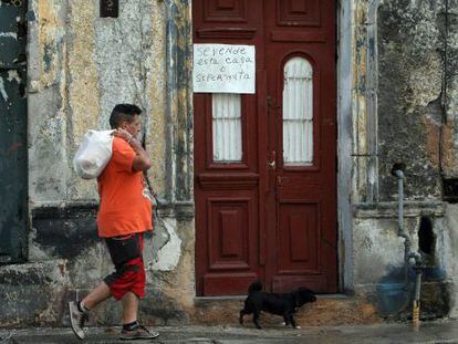 A man walking past a home up for sale in Havana, Cuba.