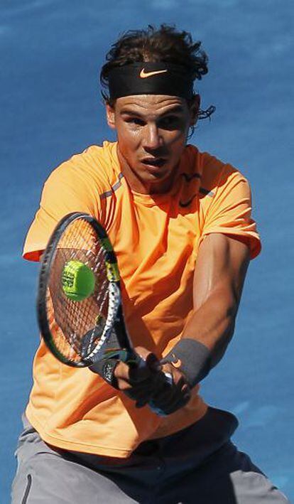 Nadal returns the ball on the new blue clay at the Madrid Open on Wednesday.