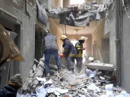 Rescuers in a building that city officials said was damaged by a missile in Kharkiv.