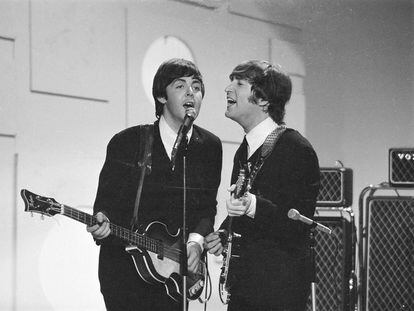 Paul McCartney and John Lennon during a performance on CBS, in September 1965, in New York.