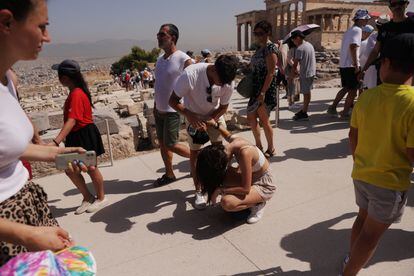 A tourist suffering from the heat at the Acropolis in Athens, July 14.
