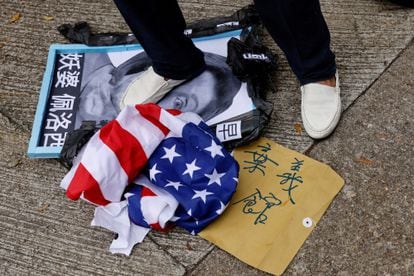 A pro-China protester tramples on a poster with Nancy Pelosi's photo in Hong Kong on Wednesday.