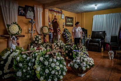Noemi looks at all the flowers donated in memory of her brother Daniel, at the family home; Iztapalapa, Mexico City.