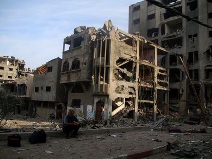 A Palestinian citizen sits outside what remains of his house after a bombing in northern Gaza.