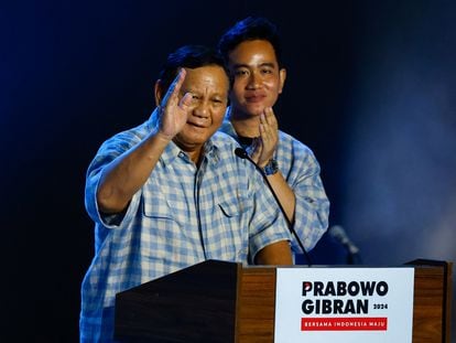 Presidential candidate Prabowo Subianto gestures to his supporters next to Vice President candidate Gibran Rakabuming Raka as Subianto claims victory after unofficial vote counts during an event to watch the results of the general election in Jakarta, Indonesia, February 14, 2024.