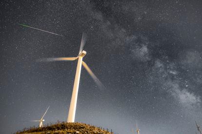 Perseid meteor and the Milky Way over the Wind Turbines of Greece's largest Wind Farm at Panachaiko mountain in Patras, Greece‬.