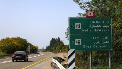 A car passes by an Erez Crossing signboard, after the Israeli cabinet approved the reopening of the crossing into northern Gaza.