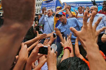 Henrique Capriles (c) greets supporters last Thursday at an rally for candidates running in municipal elections in December.